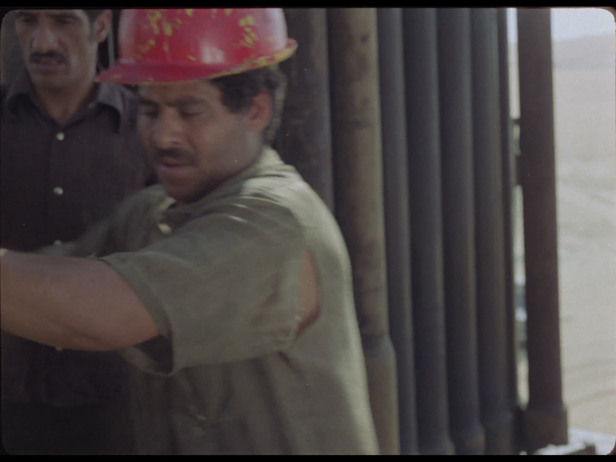Team Tighten Drill Pipes at Well Head on Drilling Platform