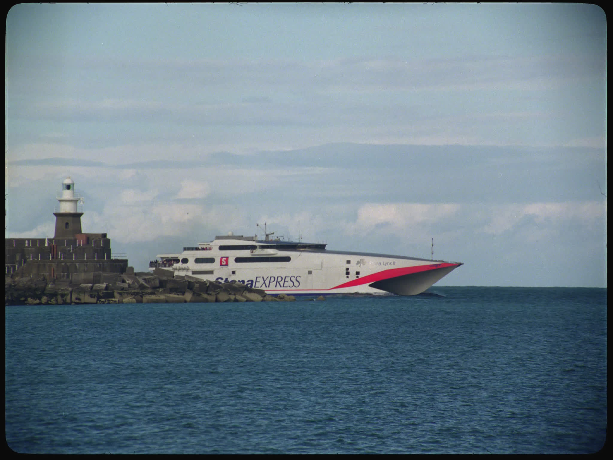 Stena Express Moving Past Harbour Wall and Lighthouse
