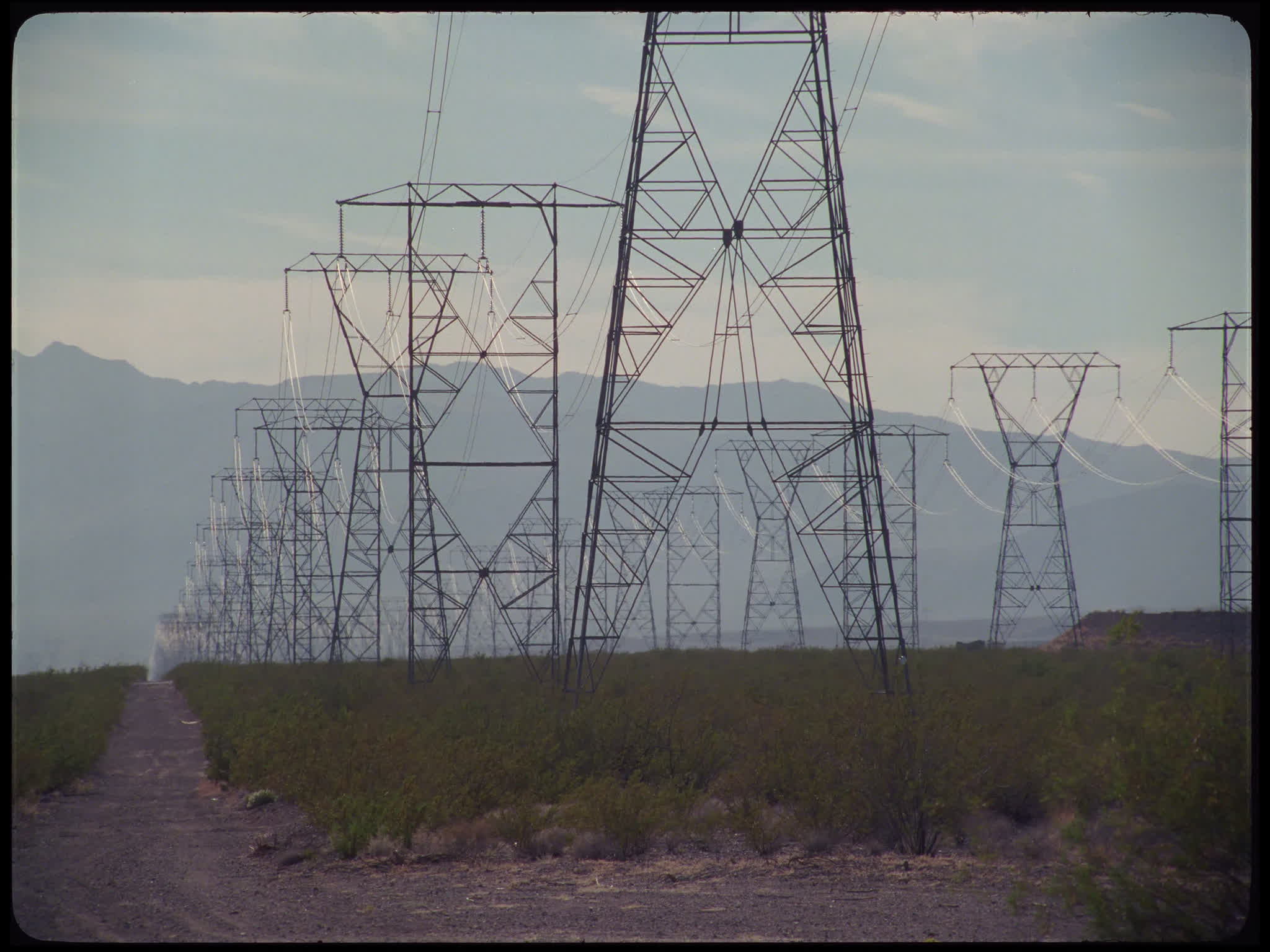 Electricity Pylons in Field