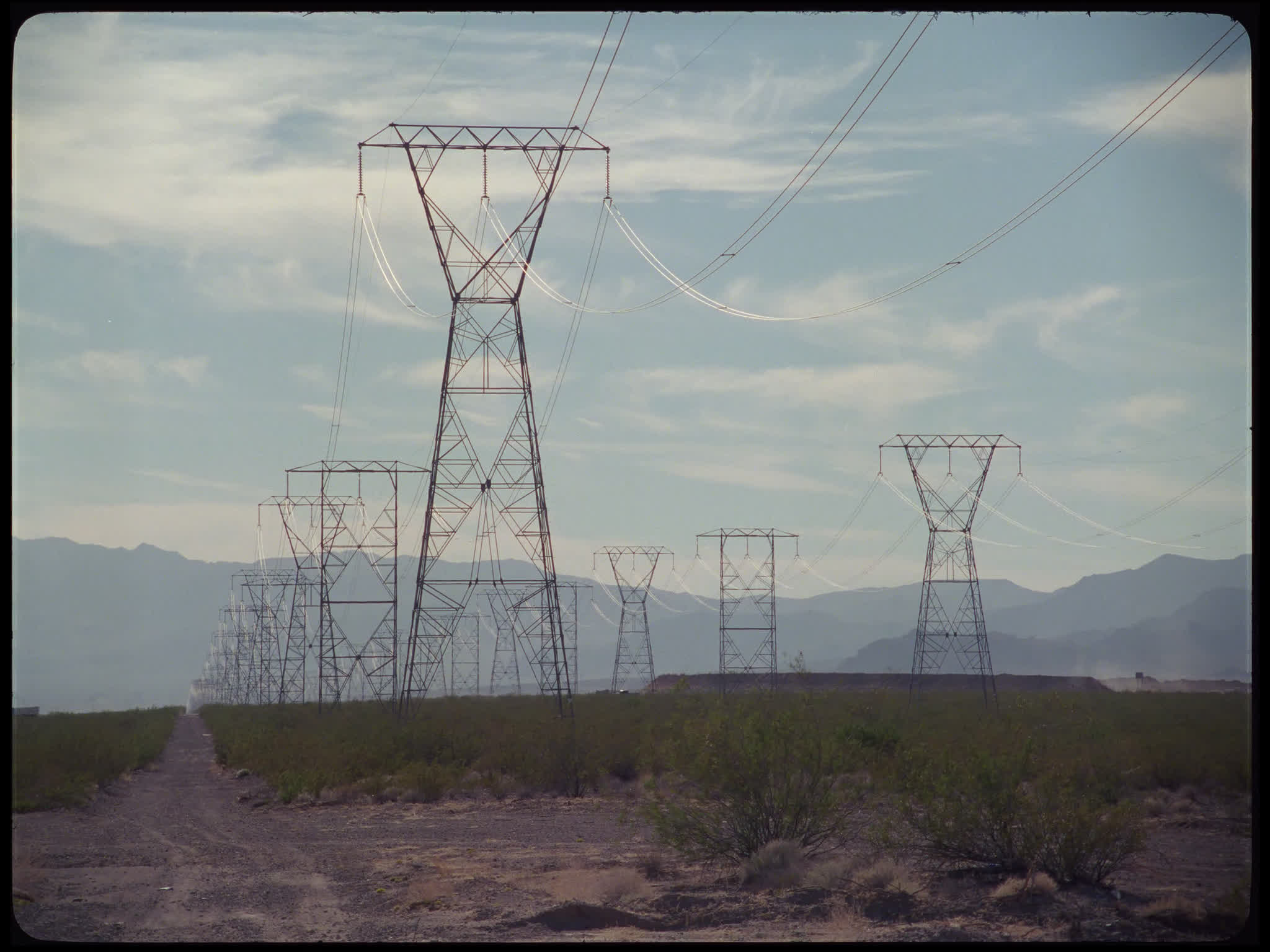 Electricity Pylons in Field