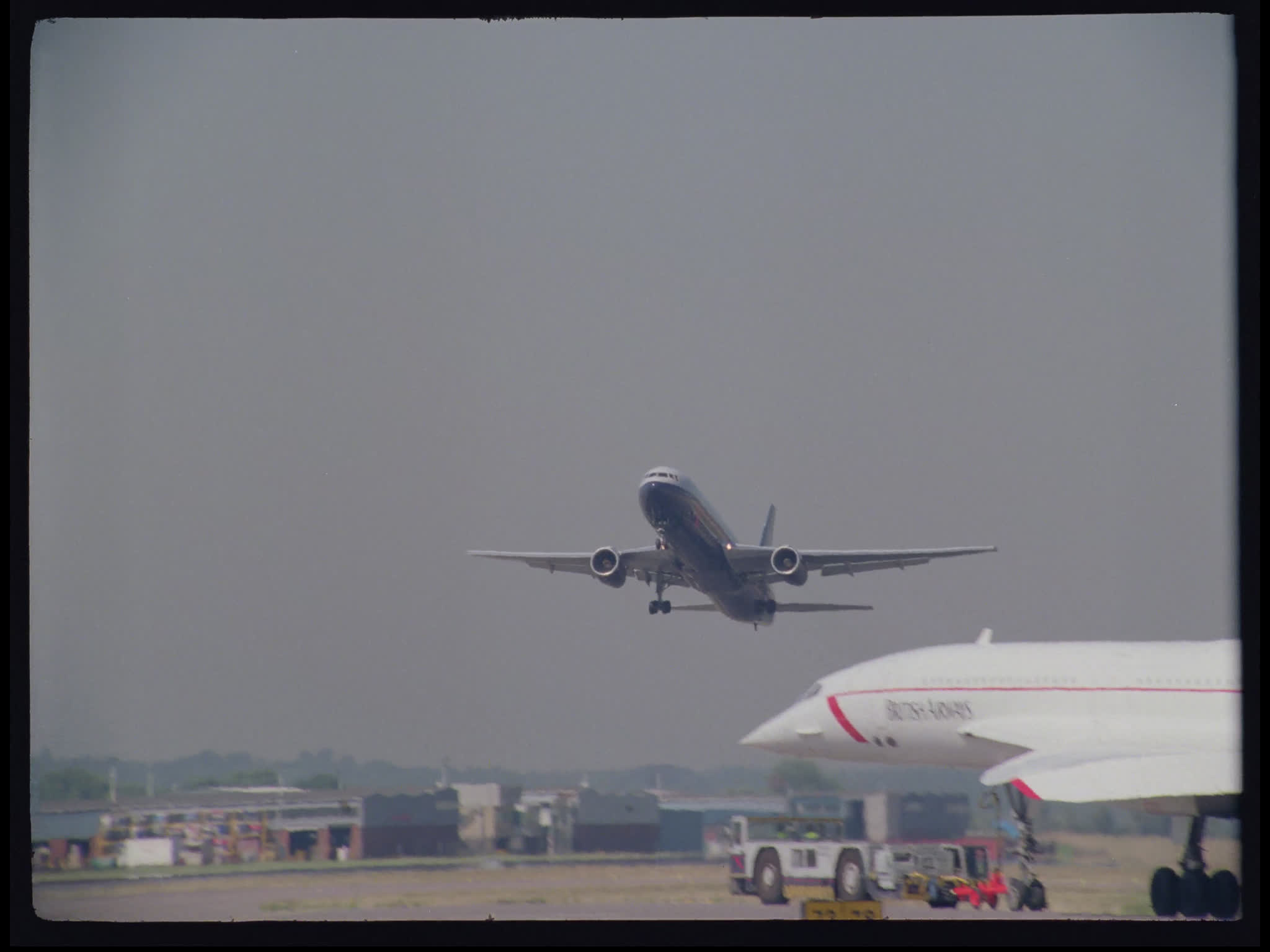 British Airways Boeing 767 Taking Off Past Concorde