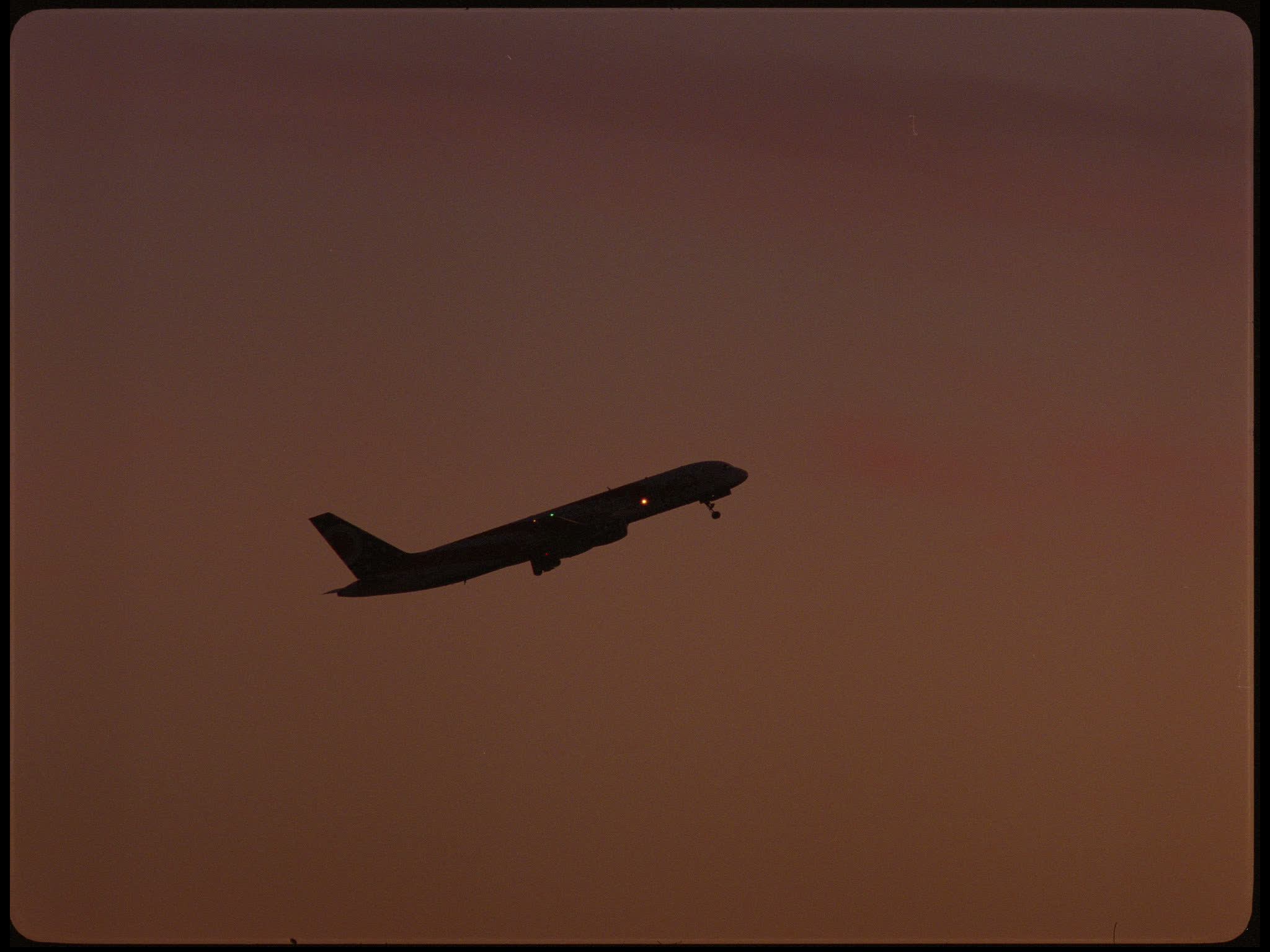 Plane Taking Off Against Sunset
