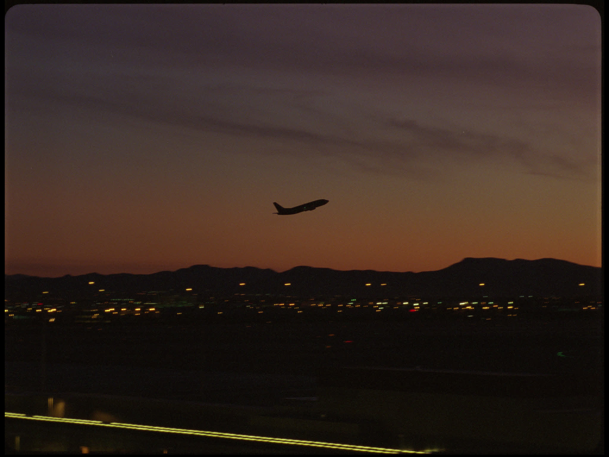 Plane Taking Off Against Sunset