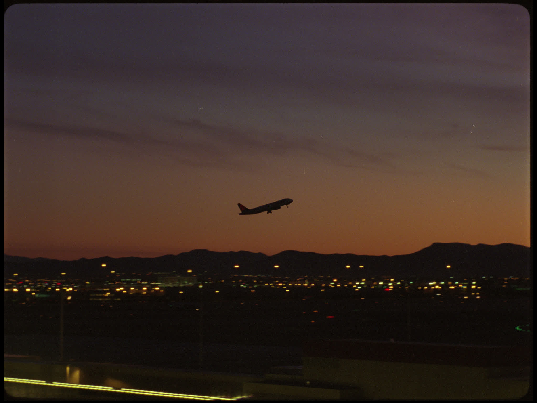 Plane Taking Off Against Sunset