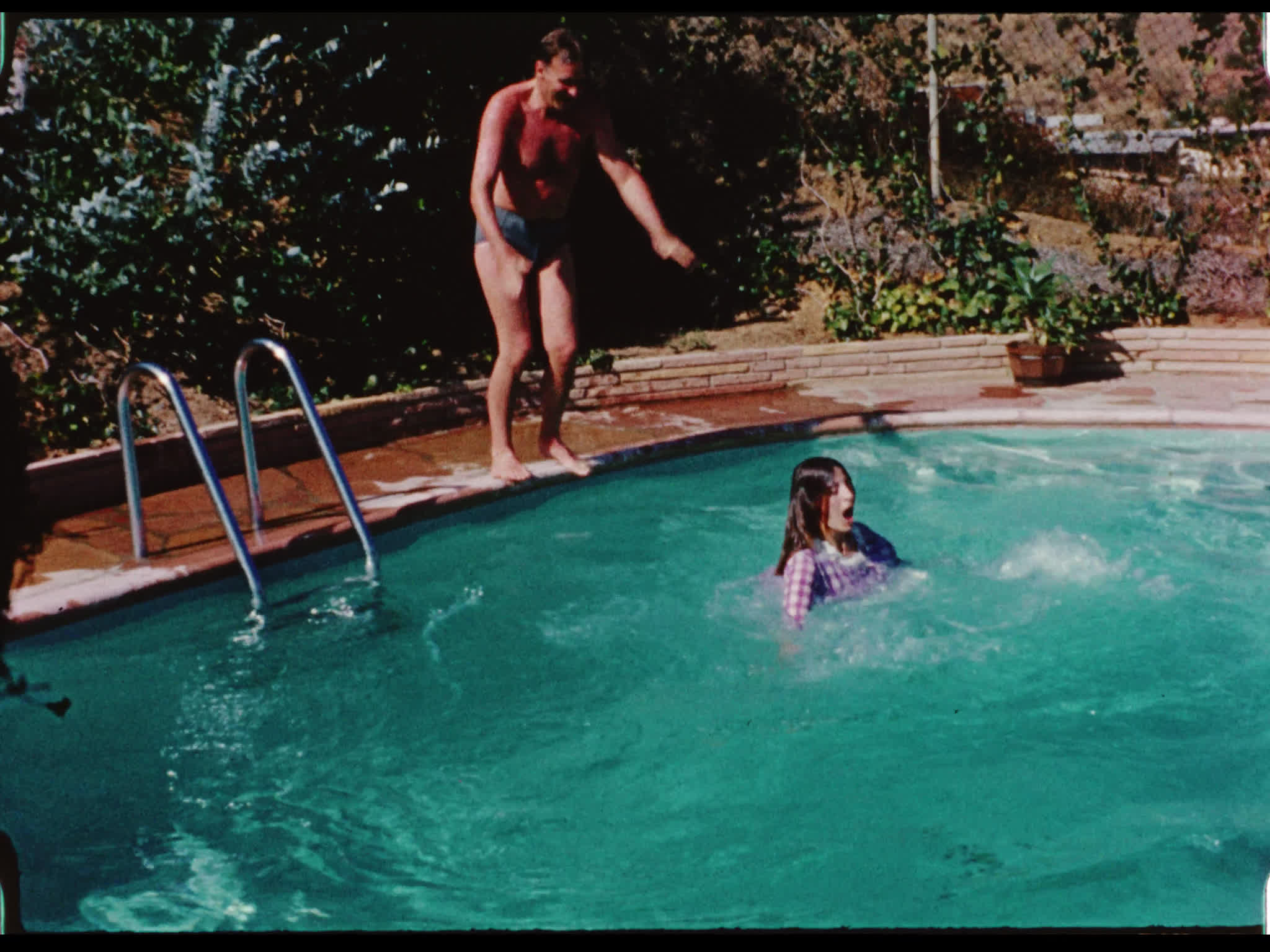Anthony Forwood Pushes Capucine into the Pool