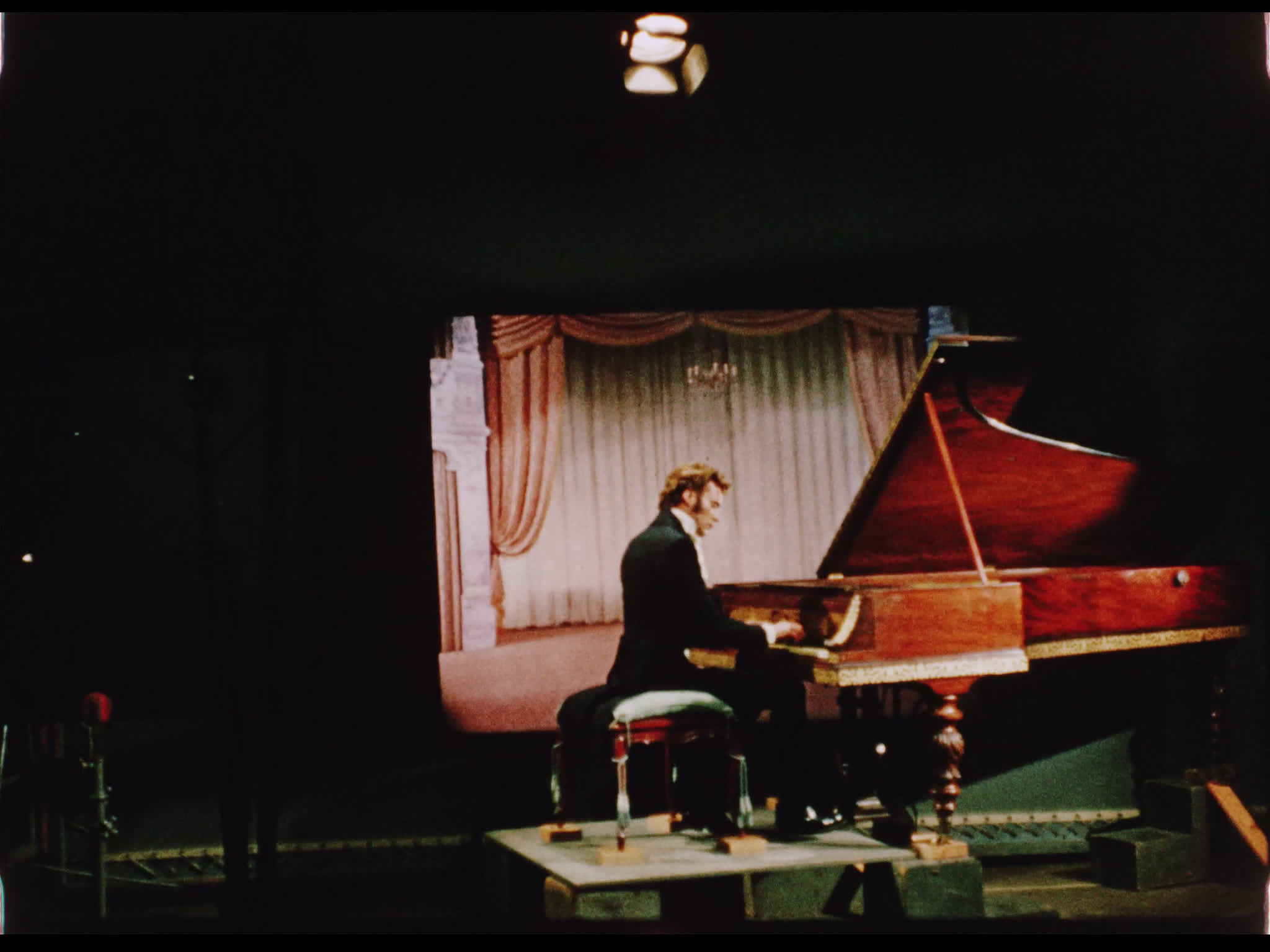 Dirk Bogarde playing piano