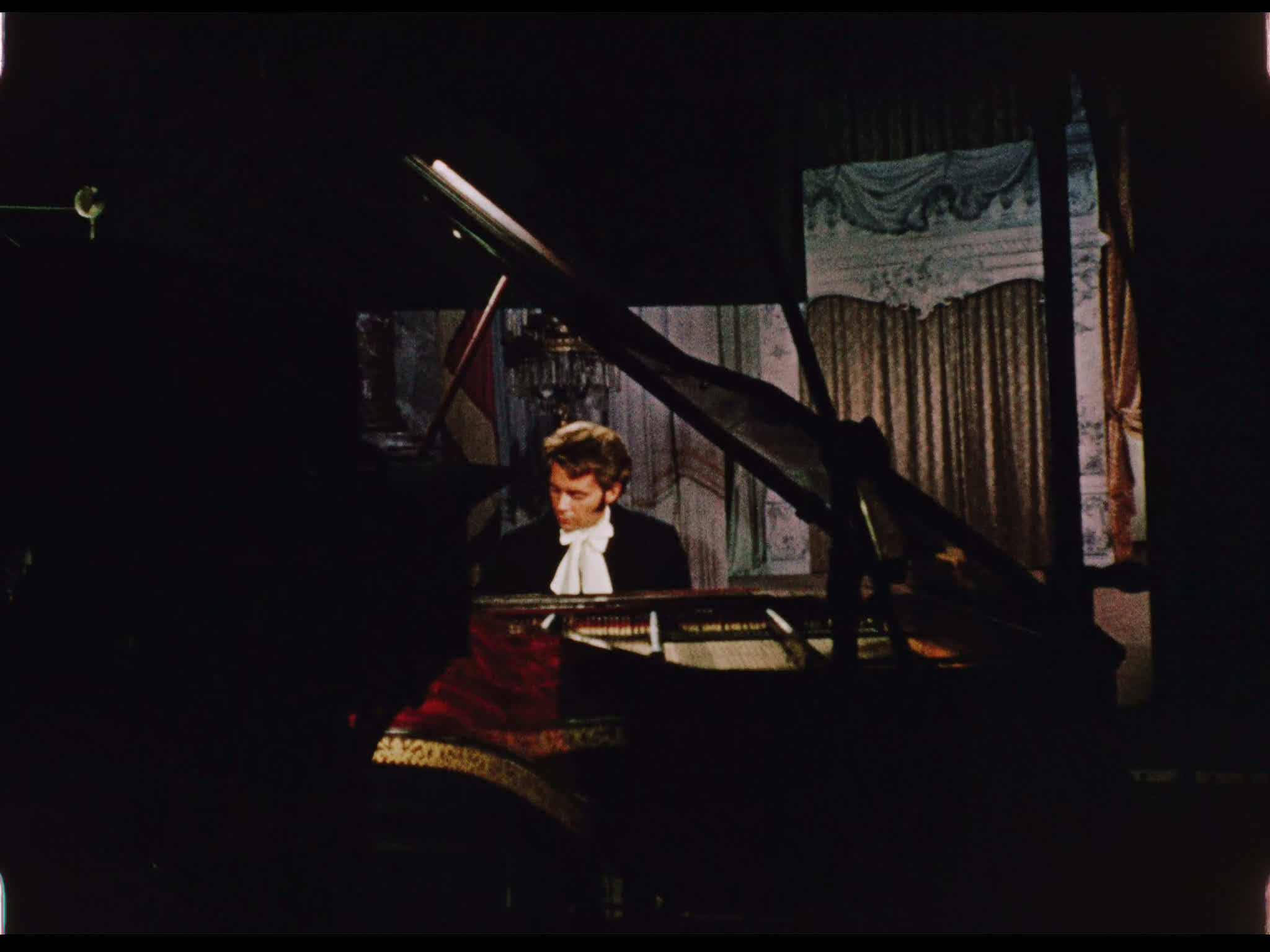 Dirk Bogarde playing piano