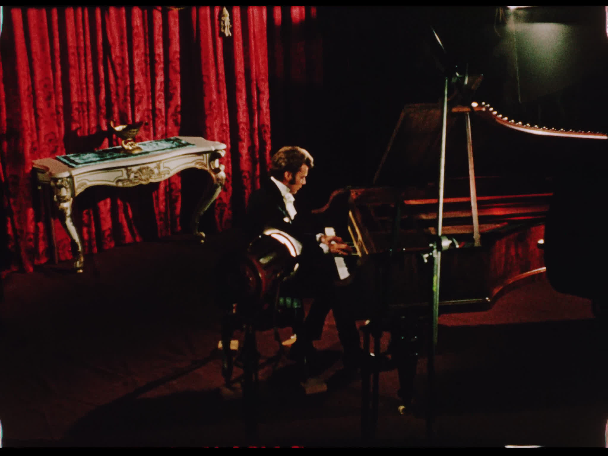 Dirk Bogarde playing piano