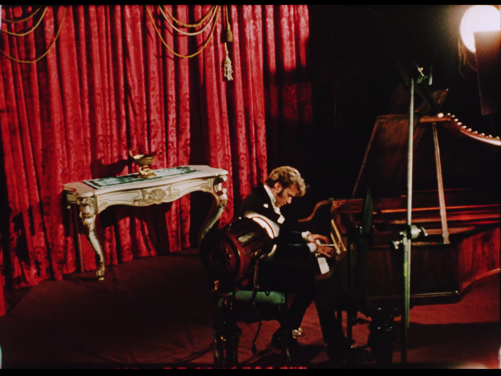 Dirk Bogarde playing piano